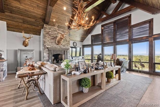 15295 E Cherry Creek S Road, Larkspur, CO 80118 - living room featuring high vaulted ceiling, a fireplace, wooden ceiling with exposed beams, plenty of natural light, and a chandelier