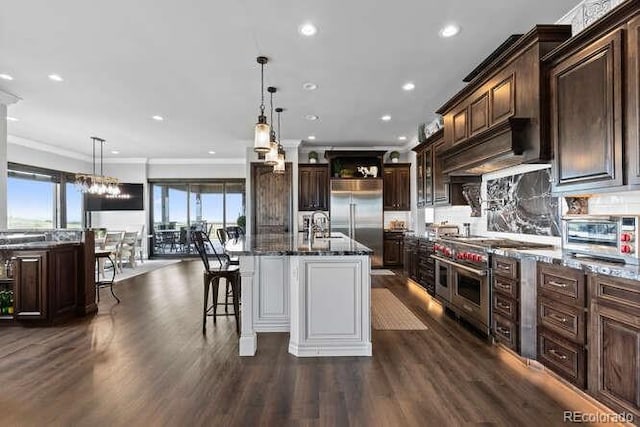 15295 E Cherry Creek S Road, Larkspur, CO 80118 - kitchen featuring high end appliances, dark stone counters, custom exhaust hood, ornamental molding, and dark brown cabinetry