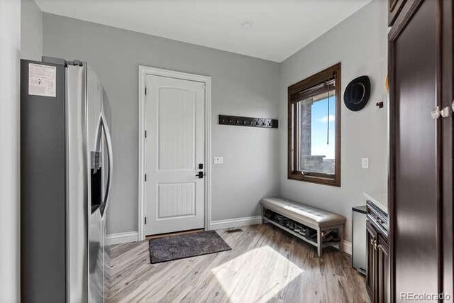15295 E Cherry Creek S Road, Larkspur, CO 80118 - entryway featuring light wood finished floors and baseboards