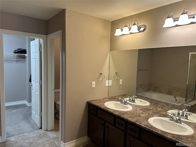 4746 Raven Run, Broomfield, CO 80023 - bathroom featuring double vanity, a sink, a garden tub, and toilet