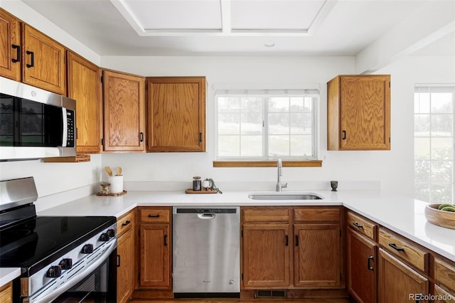 2040 S Xenia Way, Denver, CO 80231 - kitchen featuring appliances with stainless steel finishes, light countertops, and brown cabinetry
