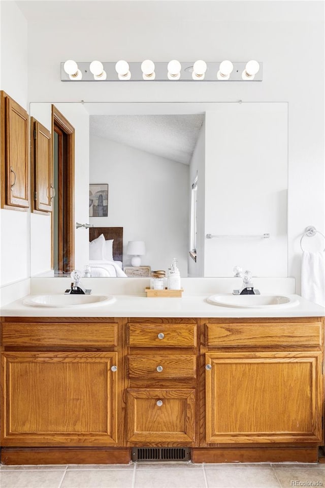 2040 S Xenia Way, Denver, CO 80231 - full bathroom with double vanity, tile patterned floors, and lofted ceiling