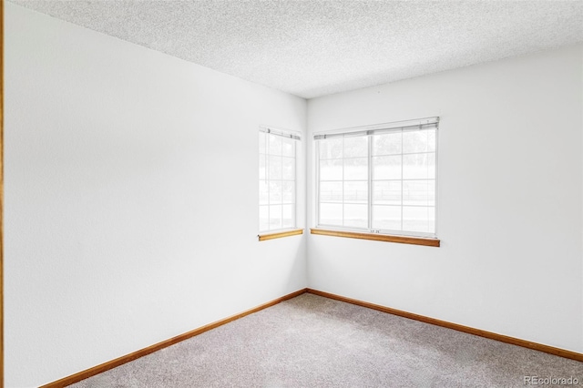 2040 S Xenia Way, Denver, CO 80231 - carpeted empty room with a textured ceiling and baseboards