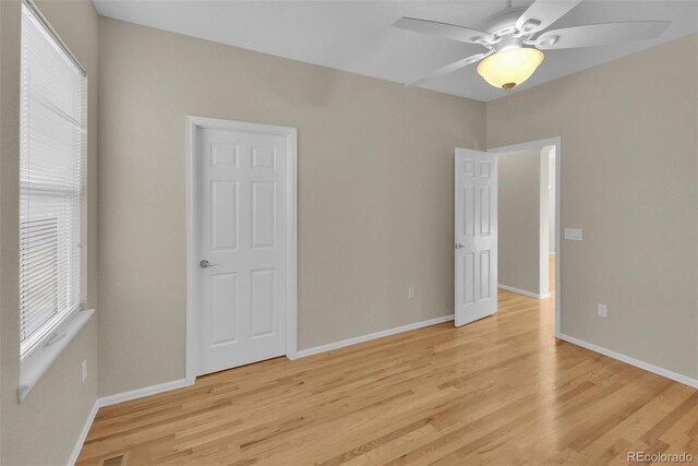 spare room featuring light hardwood / wood-style floors and ceiling fan