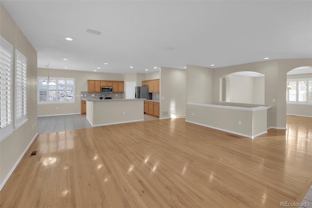 unfurnished living room with light hardwood / wood-style floors