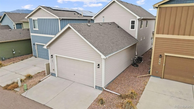 view of front of house featuring a mountain view and central AC