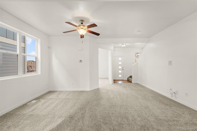 carpeted spare room with ceiling fan