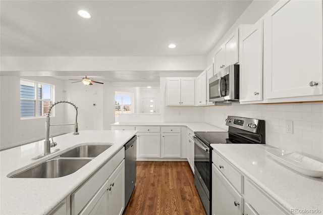 kitchen featuring dark hardwood / wood-style floors, sink, white cabinetry, and stainless steel appliances