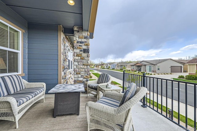 balcony featuring an outdoor living space and a residential view
