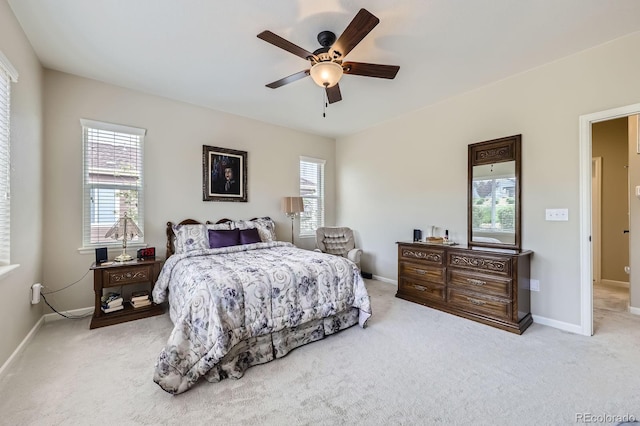 carpeted bedroom with baseboards, multiple windows, and a ceiling fan