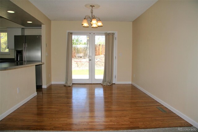 1008 Park View Ct, Castle Rock, CO 80104 - unfurnished dining area with wood finished floors, a chandelier, baseboards, french doors, and recessed lighting
