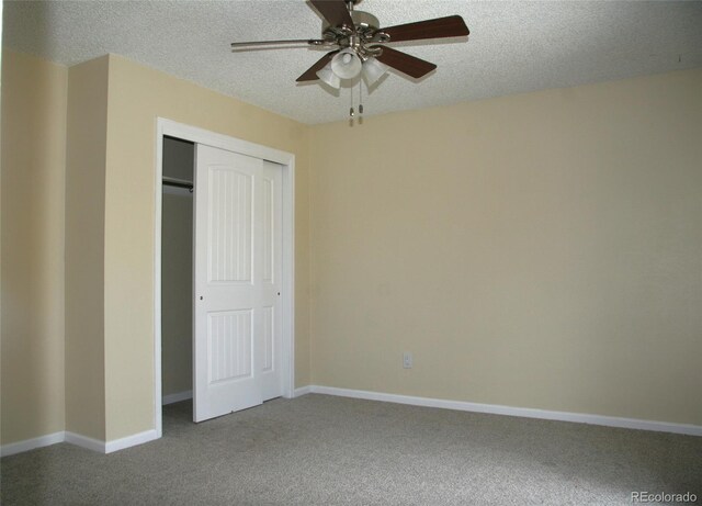 1008 Park View Ct, Castle Rock, CO 80104 - unfurnished bedroom featuring carpet floors, a textured ceiling, a closet, baseboards, and a ceiling fan