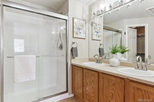 bathroom with tile patterned flooring, vanity, and an enclosed shower