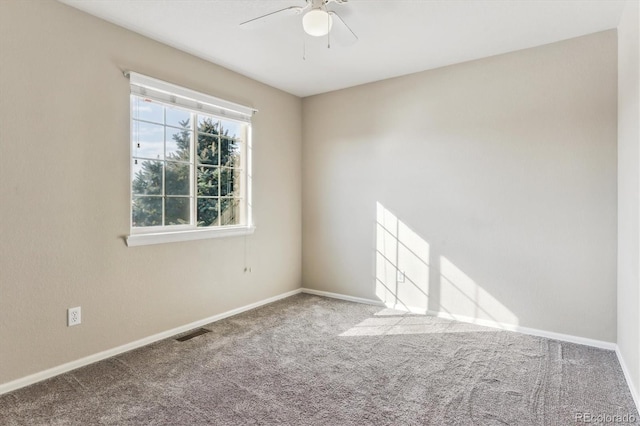 empty room with ceiling fan and carpet