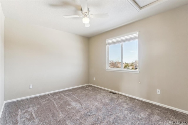 spare room featuring ceiling fan and carpet