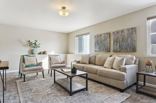 living room featuring carpet flooring and a textured ceiling