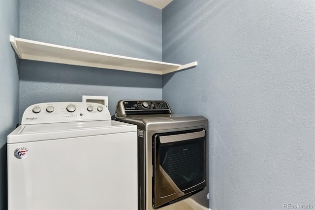 washroom featuring washer and dryer