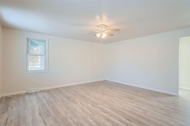 empty room featuring ceiling fan and light hardwood / wood-style flooring