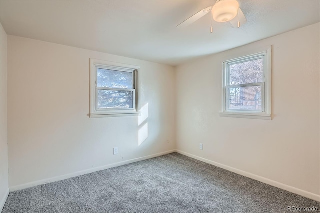 empty room featuring carpet flooring, ceiling fan, and plenty of natural light