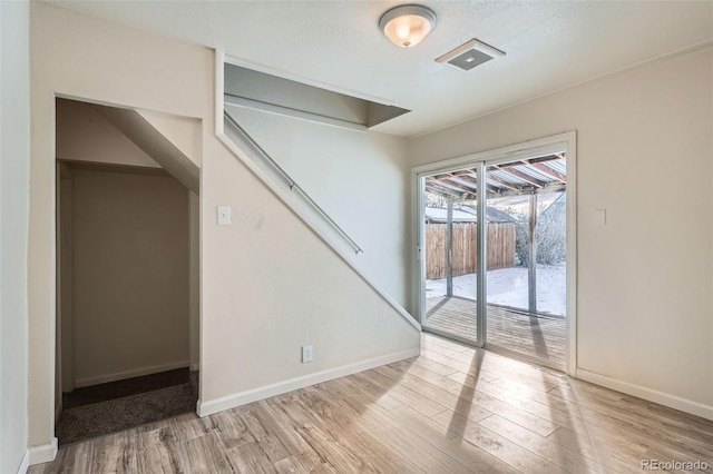 spare room featuring light hardwood / wood-style floors