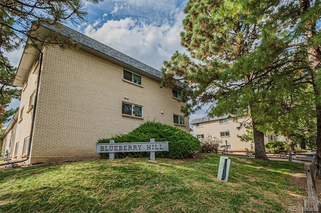 view of side of home featuring a lawn