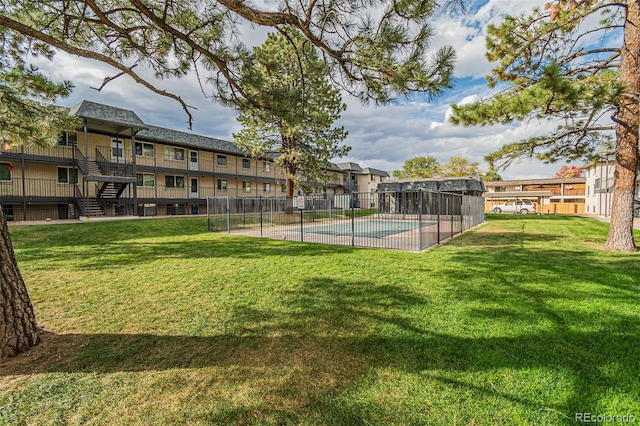 exterior space featuring a community pool and a lawn