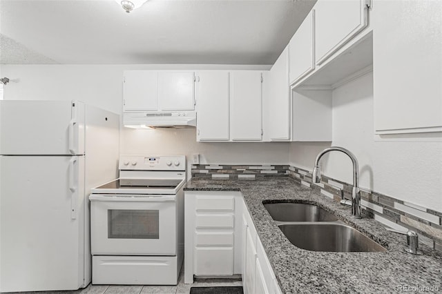 kitchen with white appliances, sink, backsplash, white cabinetry, and dark stone countertops