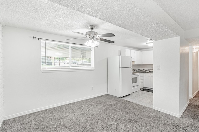 unfurnished living room with light carpet, a textured ceiling, and ceiling fan