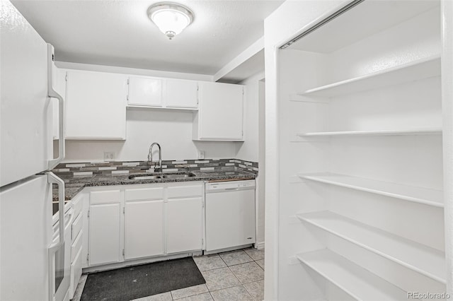 kitchen featuring sink, white cabinetry, white appliances, and dark stone countertops