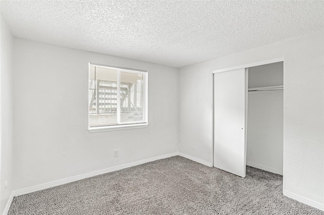 unfurnished bedroom with a closet, a textured ceiling, and carpet floors