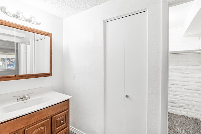 bathroom featuring vanity and a textured ceiling