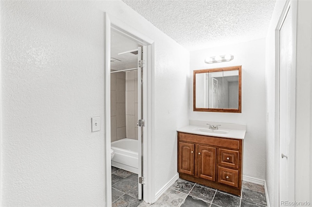 bathroom with vanity, a textured ceiling, and shower / bathtub combination