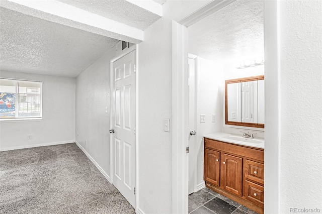 bathroom with vanity and a textured ceiling