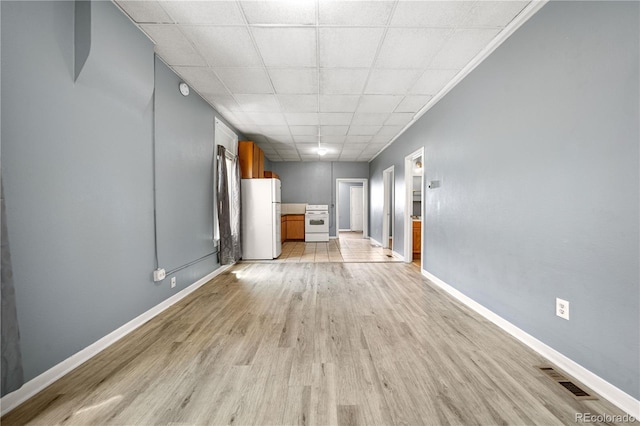 741 Mariposa St, Denver, CO 80204 - unfurnished room with light wood-type flooring, baseboards, and a paneled ceiling