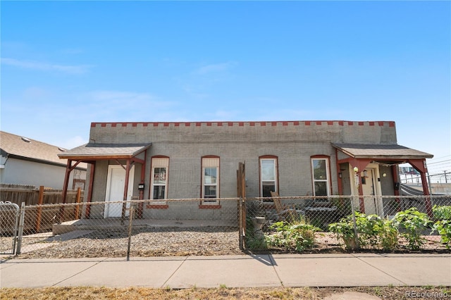 741 Mariposa St, Denver, CO 80204 - view of property with a fenced front yard and brick siding