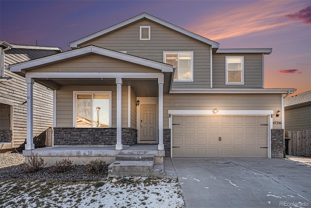 view of front of property with a porch and a garage