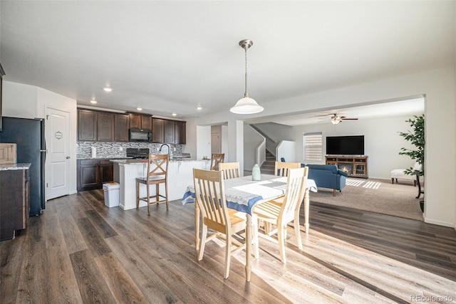 dining space featuring ceiling fan and dark hardwood / wood-style flooring