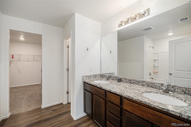 bathroom featuring vanity, shower / bath combination, and wood-type flooring