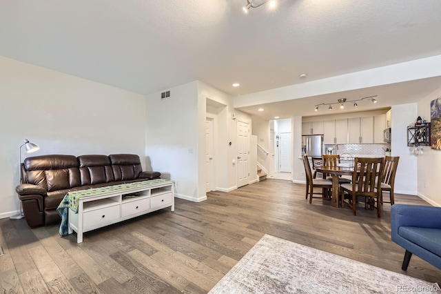 4555 S Auckland Ct, Aurora, CO 80015 - living area with stairs, wood finished floors, track lighting, and recessed lighting