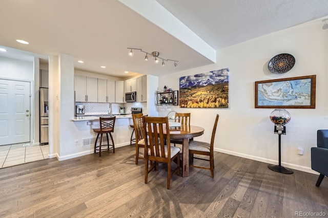 4555 S Auckland Ct, Aurora, CO 80015 - dining space with wood finished floors and recessed lighting