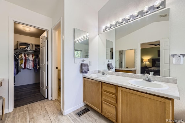4555 S Auckland Ct, Aurora, CO 80015 - ensuite bathroom with double vanity, a ceiling fan, and a spacious closet