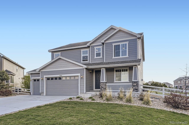 craftsman house featuring a porch, driveway, an attached garage, and stone siding