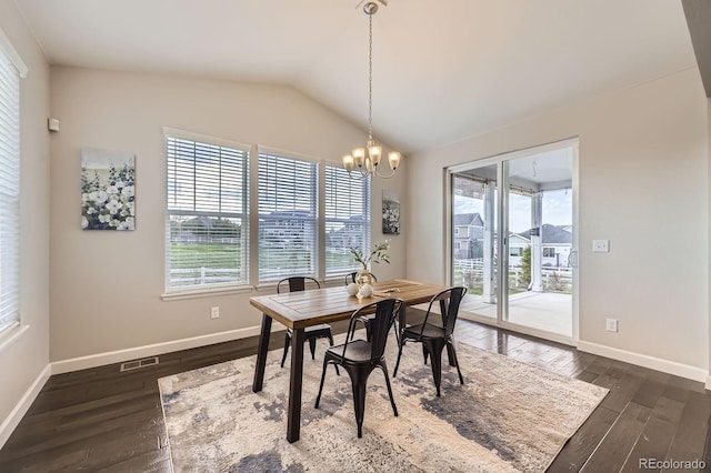 dining space featuring dark wood-style floors, vaulted ceiling, baseboards, and a chandelier