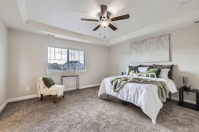carpeted bedroom with a raised ceiling, crown molding, baseboards, and a ceiling fan