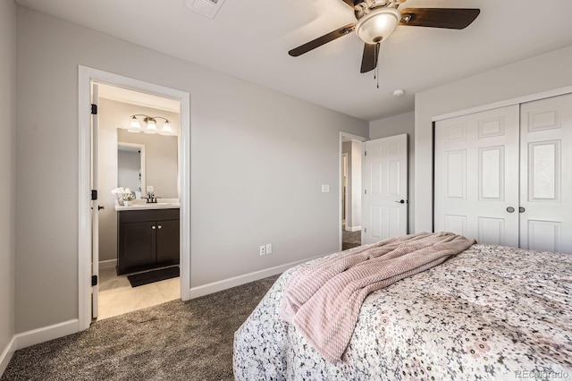 bedroom featuring carpet flooring, a closet, baseboards, connected bathroom, and ceiling fan