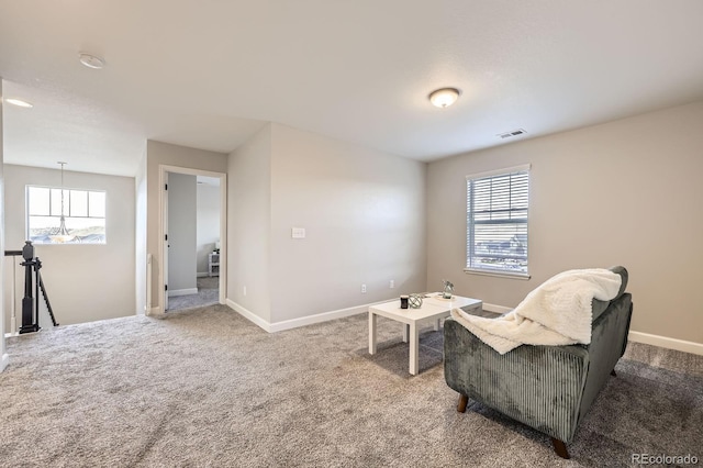 living area featuring carpet and baseboards