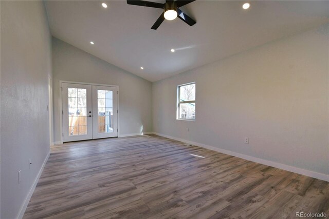 empty room with ceiling fan, french doors, high vaulted ceiling, and hardwood / wood-style flooring