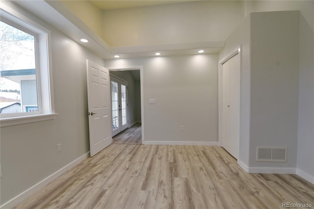 interior space with french doors, light hardwood / wood-style flooring, and plenty of natural light