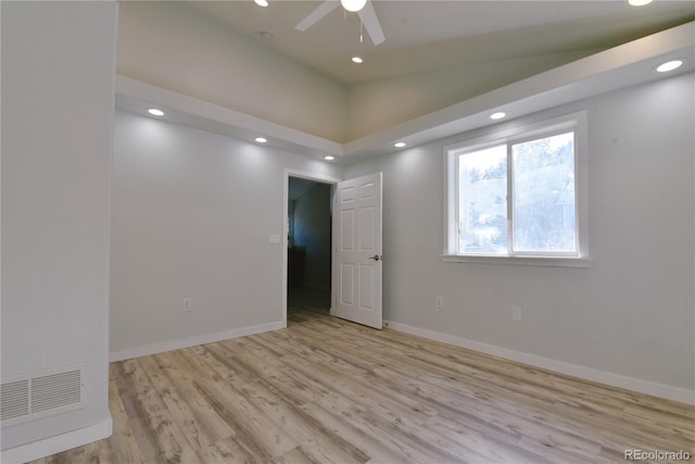 spare room featuring ceiling fan, light hardwood / wood-style floors, and vaulted ceiling