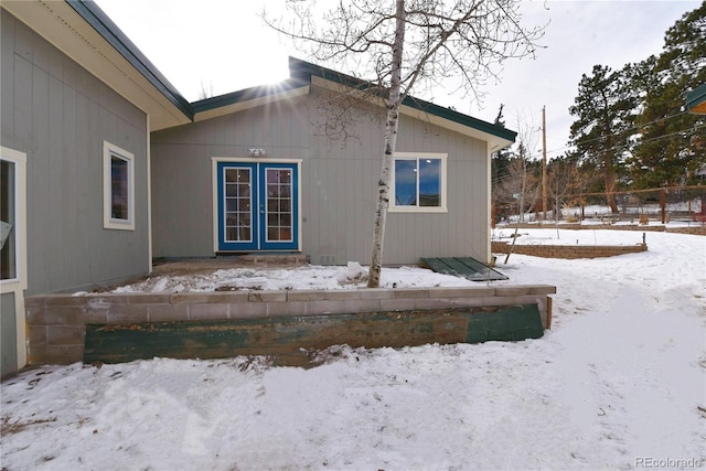 view of snow covered rear of property